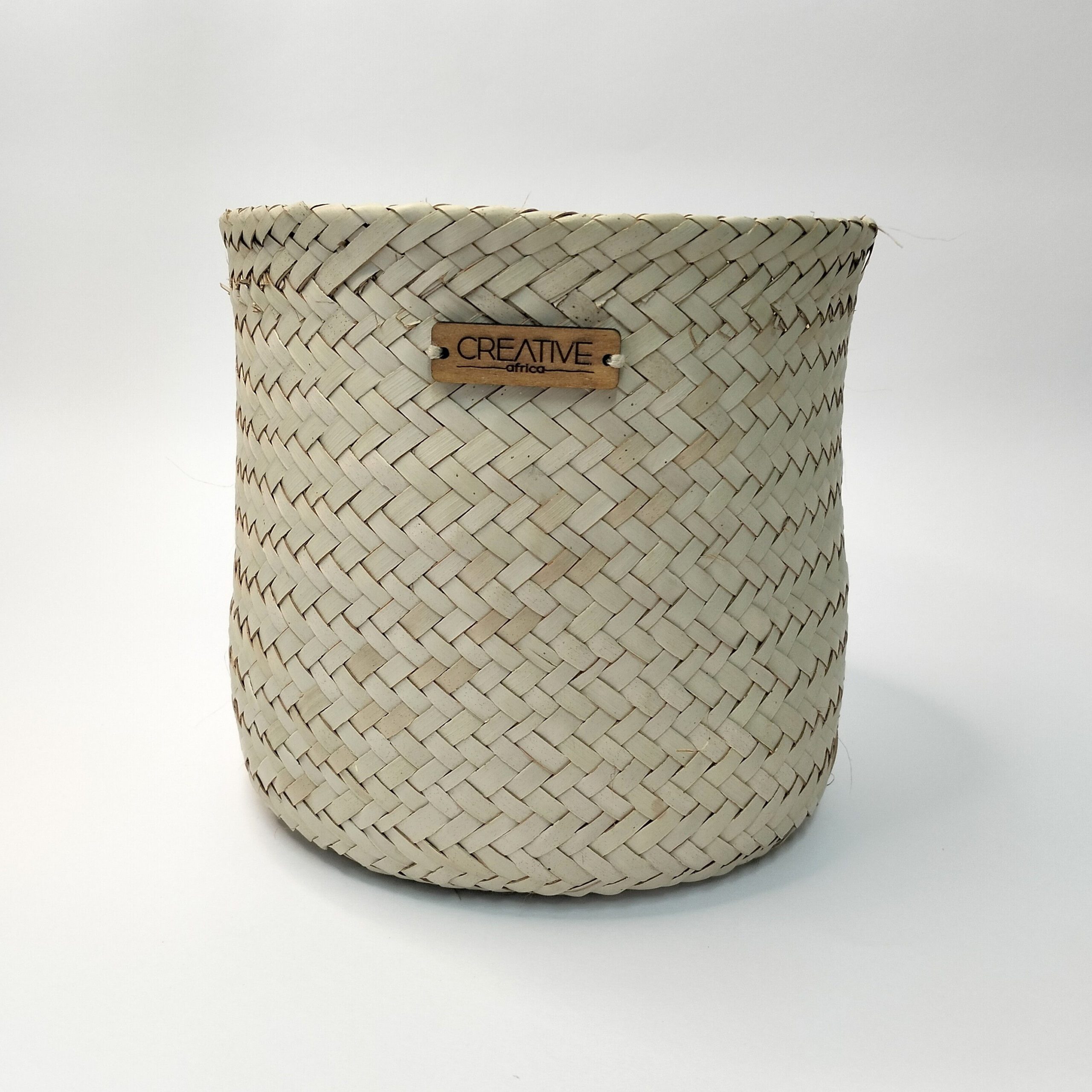 Cesta Artesanal Pequena em Folha de Palma Natural. Está sobre um fundo branco.