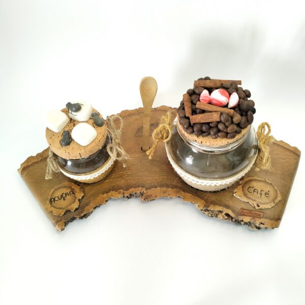 Conjunto artesanal para café e açúcar em madeira de sobreiro, tem frasco para o café, frasco para açúcar e uma colher de madeira sobre a base Está sobre um fundo branco.